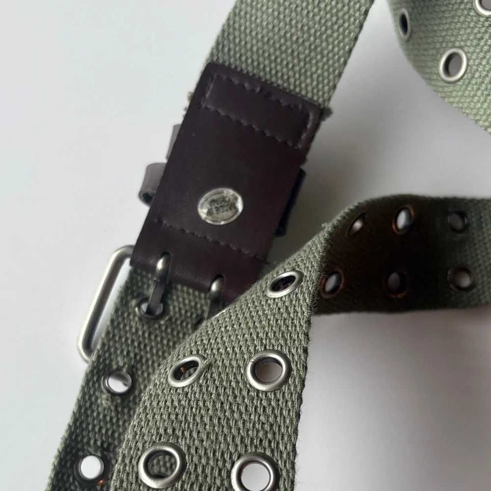 Olive Green Canvas Belt with brown accents. Silver tone hook loops.